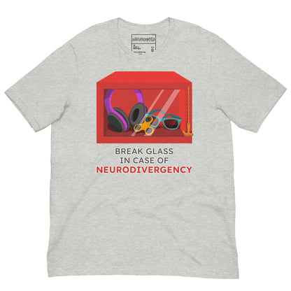 gray t-shirt featuring a red emergency box illustration filled with noise-canceling headphones, a fidget spinner, sunglasses, and a small anchor. Below the box, bold text reads 'Break Glass in Case of Neurodivergency' with 'Neurodivergency' highlighted in red.