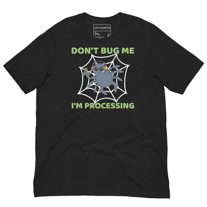black t-shirt featuring a cartoon spider sitting in a web, wearing orange headphones and holding a green fidget spinner. Above the spider, bold green text reads 'Don't Bug Me,' and below it says 'I'm Processing'.