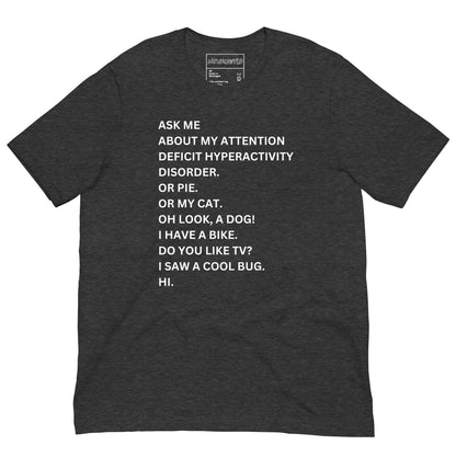 green t-shirt with white text in a playful, scattered style that reads: 'ASK ME ABOUT MY ATTENTION DEFICIT HYPERACTIVITY DISORDER. OR PIE. OR MY CAT. OH LOOK, A DOG! I HAVE A BIKE. DO YOU LIKE TV? I SAW A COOL BUG. HI.'