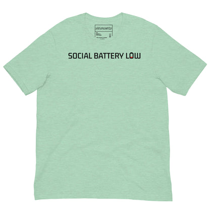 Light green t-shirt with bold black text reading ‘SOCIAL BATTERY LOW,’ featuring a small red low-battery icon at the end, symbolizing introvert and neurodivergent humor.