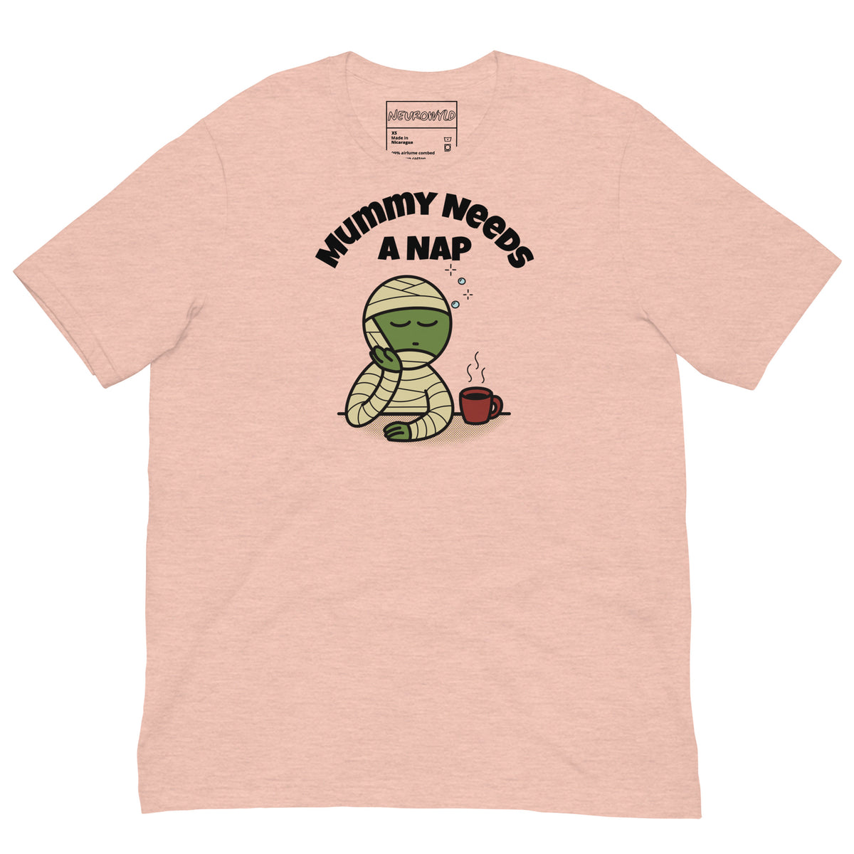Light pink t-shirt featuring a sleepy green mummy resting its head on one hand beside a steaming coffee cup. Above, the text reads 'Mummy Needs A Nap' in bold black letters.