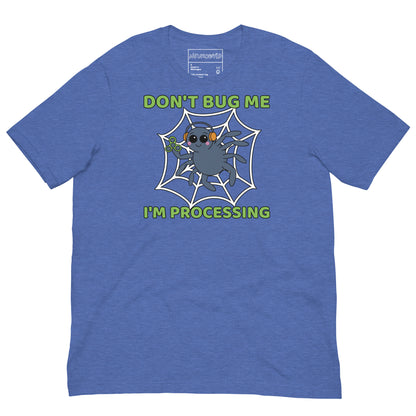 blue t-shirt featuring a cartoon spider sitting in a web, wearing orange headphones and holding a green fidget spinner. Above the spider, bold green text reads 'Don't Bug Me,' and below it says 'I'm Processing'.