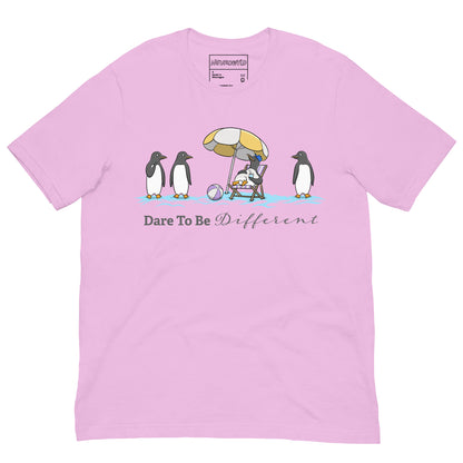 pink t-shirt featuring three penguins standing in a row while a fourth penguin lounges under a beach umbrella with a drink, surrounded by sand and a beach ball. Below the illustration, the text reads 'Dare To Be Different' in bold and script font.
