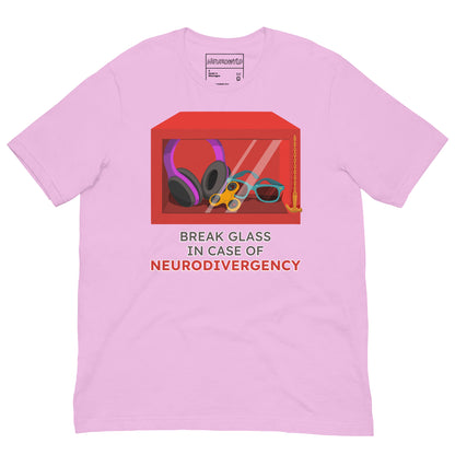 pink t-shirt featuring a red emergency box illustration filled with noise-canceling headphones, a fidget spinner, sunglasses, and a small anchor. Below the box, bold text reads 'Break Glass in Case of Neurodivergency' with 'Neurodivergency' highlighted in red.