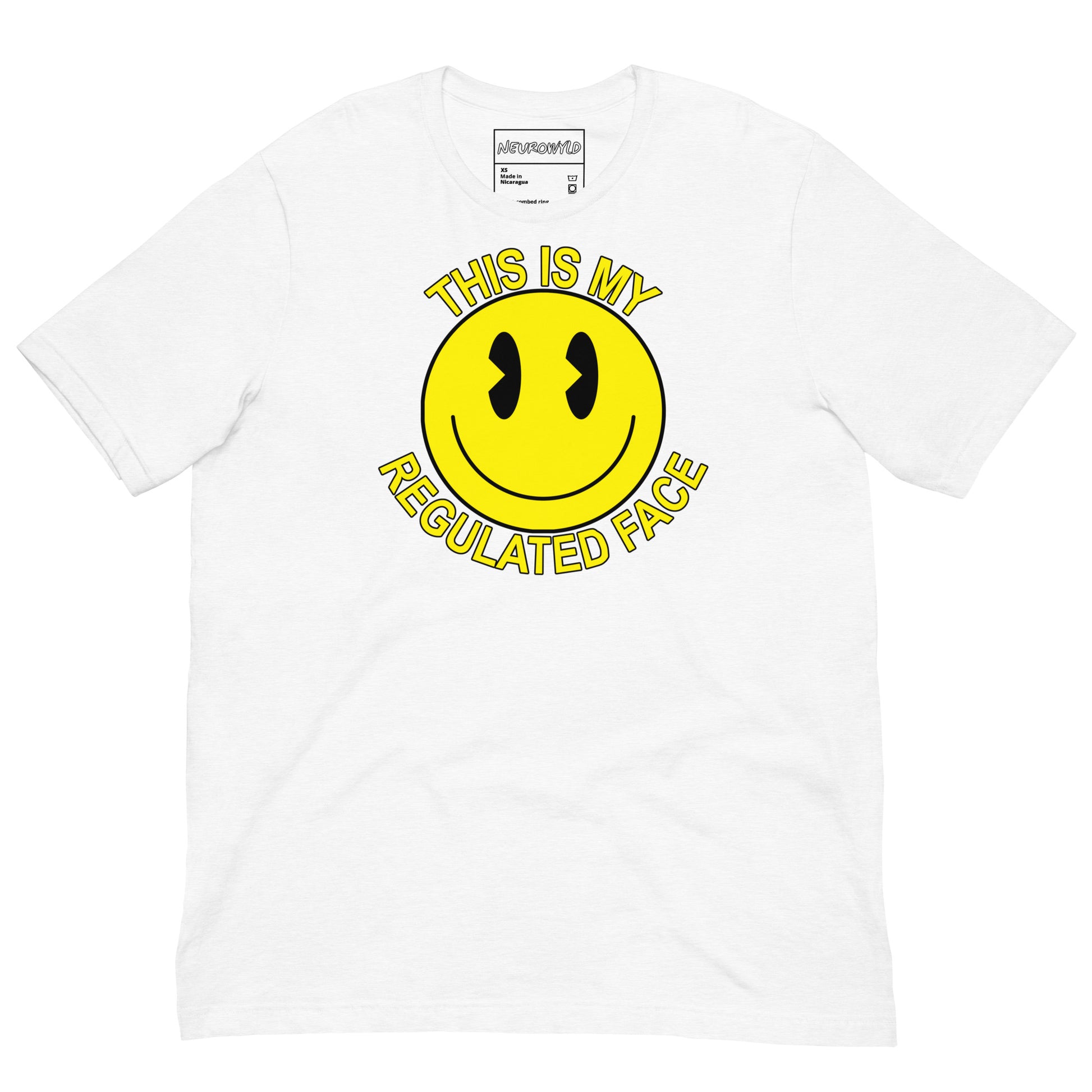 White t-shirt with a large yellow smiley face graphic. Text above and below the face reads ‘This Is My Regulated Face,’ combining humor and neurodivergent pride.