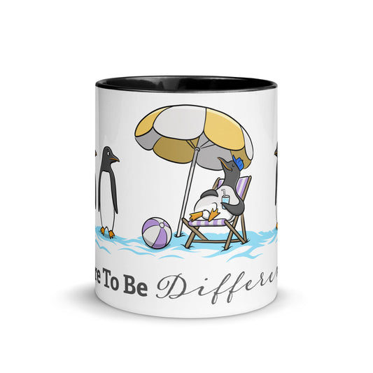 White ceramic mug with black interior featuring a beach scene of penguins and the phrase “Dare To Be Different” — playful neurodivergent identity design